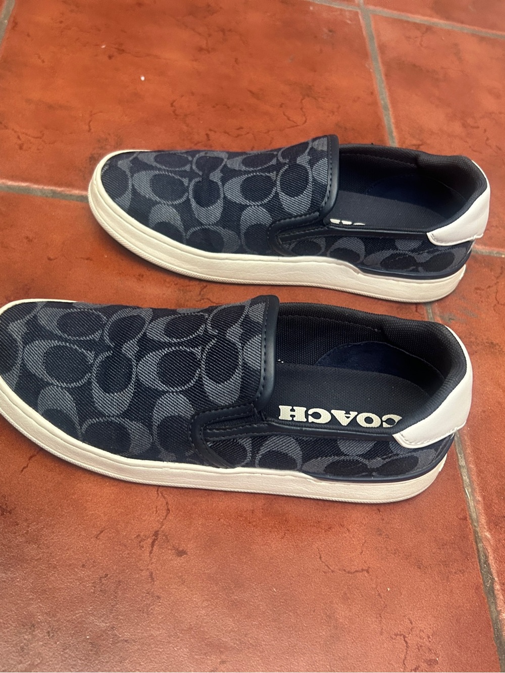 Coach women’s Black Navy Signature Slip-On Sneakers